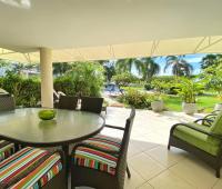 Palm Beach 211 Barbados Beachfront Vacation Condo Rental Covered Patio with Dining and Lounge Seating