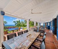 Covered outdoor dining terrace at Apples House, a luxury holiday rental villa in Rock Dundo, Barbados, overlooking the pool and Caribbean Sea