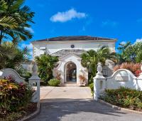 Stunning front entrance of Benjoli Breeze, a luxury villa in Royal Westmoreland, Barbados, with tropical landscaping and grand archways.