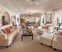 Spacious, elegantly designed living room with vaulted ceilings, plush seating, and open access to the pool at Benjoli Breeze, Barbados.