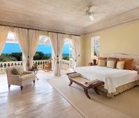 Luxurious master suite with a private balcony, ocean views, and elegant Caribbean-inspired décor at Benjoli Breeze, Barbados.