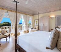 Beautifully designed bedroom with ocean views and direct access to a private balcony at Benjoli Breeze, Royal Westmoreland.