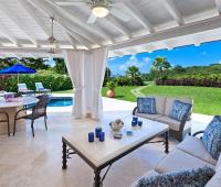 Spacious covered patio at Coconut Grove 2, featuring a private pool, lush tropical gardens, and stunning golf course views at Royal Westmoreland, Barbados.