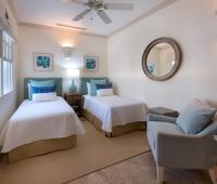 Charming guest bedroom at Howzat Villa, Barbados, with plush bedding, stylish accents, and a serene ambiance.