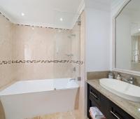 Luxurious bathroom featuring a walk-in shower and sleek vanity with modern finishes at Ixora, Royal Westmoreland, Barbados