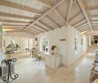 Charming walkway with lush tropical greenery, leading to a private outdoor sitting area at Ixora, Royal Westmoreland, Barbados