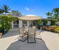 Relaxing covered seating area with comfortable chairs and tropical views on the pool deck at Ixora Royal Westmoreland, Barbados