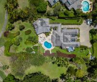 Aerial shot of Ixora Royal Westmoreland, showcasing the elegant villa, pool, and golf course views at the prestigious Barbados estate