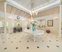 Luxurious foyer of Ixora Villa, featuring soaring ceilings, a chandelier, and marble floors creating a grand first impression