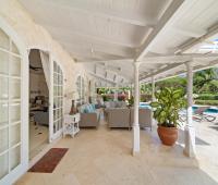 Outdoor patio area at Ixora Villa with elegant seating and tropical garden views, perfect for relaxing and entertaining