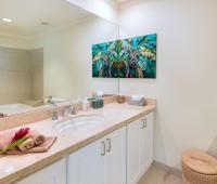 A well-appointed third bathroom at Palm Beach 101 in Barbados, featuring a walk-in shower, neutral-toned vanity, and stylish accents.