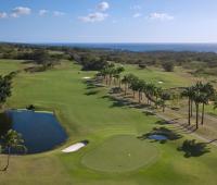 Stunning aerial view of Royal Westmoreland Golf Course, Barbados, featuring lush fairways, ocean views, and palm-lined greens.