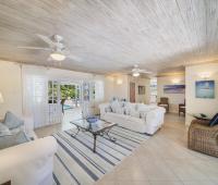 Bright and airy living room at Sandalwood House, Sandy Lane, featuring comfortable seating and access to the pool.