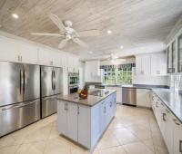 Modern, fully equipped kitchen at Sandalwood House, Barbados, with stainless steel appliances and spacious countertops.