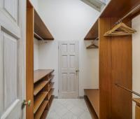 Walk-in closet at Sandalwood House, complete with ample storage space and shelving.