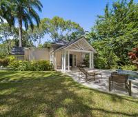 Secluded garden cottage patio at Sandalwood House, featuring lounge chairs, a small pool, and surrounded by lush tropical landscaping