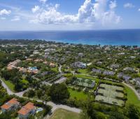 Another high-angle view over Sugar Hill Resort, showcasing the exclusive amenities including multiple tennis courts, expansive green spaces, and proximity to Barbados’ scenic coastline, ideal for a relaxing stay.