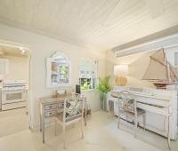 A quaint corner at Seascape villa in Barbados, featuring a charming piano, vintage-style desk, and soft tropical decor, creating a serene space for holiday rental guests.