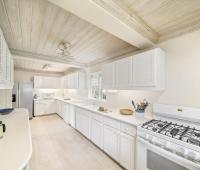 A fully equipped kitchen at Seascape villa in Barbados, showcasing a bright and functional space for preparing meals during a beachfront vacation rental.