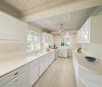 A modern and spacious kitchen at Seascape villa in Barbados, featuring ample counter space, white cabinetry, and a light, airy design perfect for holiday rental convenience.