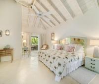 Image of a charming bedroom with garden views at Seascape, Barbados: A serene and inviting bedroom designed for comfort, with elegant furniture, soft lighting, and garden views, offering a perfect escape in this luxury Barbados villa rental.