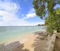 The serene beachfront of Seascape in Barbados, showcasing soft white sands and calm turquoise waters, offers guests the ultimate in beachfront holiday rentals on the island’s west coast.