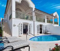 Sugar Cane Ridge 12 in Royal Westmoreland, Barbados—an elegant 4-bedroom villa with a private pool, sun loungers, and stunning golf course views.