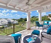Enjoy panoramic golf course views from the private terrace of Sugar Cane Ridge 12 in Barbados, complete with plush outdoor seating for relaxation.