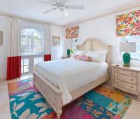 Bright and cheerful third bedroom with colorful accents, a queen-sized bed, and natural light at Sugar Cane Ridge 22.