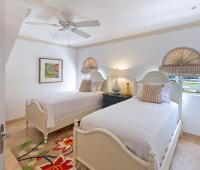 Stylish twin-bedroom with tropical-inspired décor, ideal for children or additional guests at Sugar Cane Ridge 22, Royal Westmoreland. 