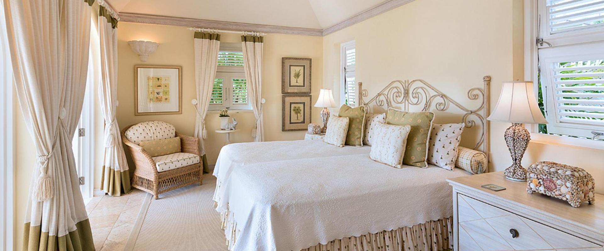 Charming guest bedroom with soft neutral tones, elegant décor, and garden views at Benjoli Breeze, Barbados.