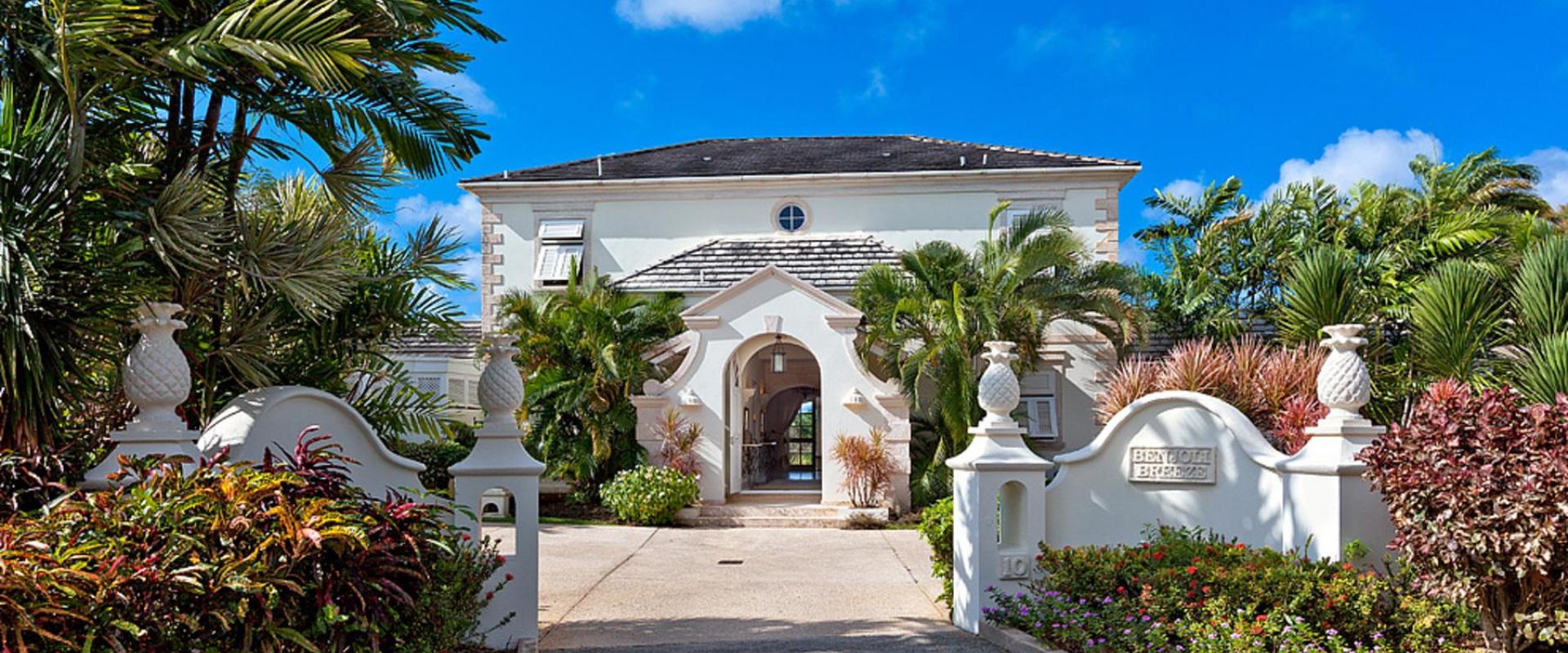 Stunning front entrance of Benjoli Breeze, a luxury villa in Royal Westmoreland, Barbados, with tropical landscaping and grand archways.