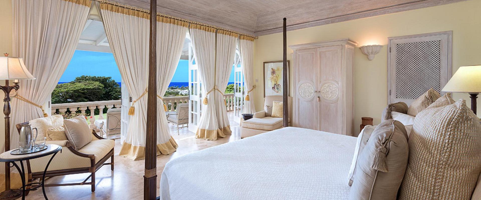 Beautifully designed bedroom with ocean views and direct access to a private balcony at Benjoli Breeze, Royal Westmoreland.