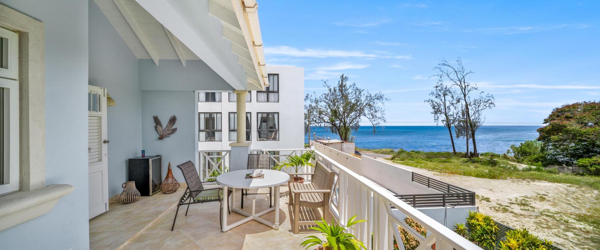 Private master suite patio with stunning ocean views and outdoor seating at Blue Waters 1, the perfect holiday home in Barbados near Miami Beach.