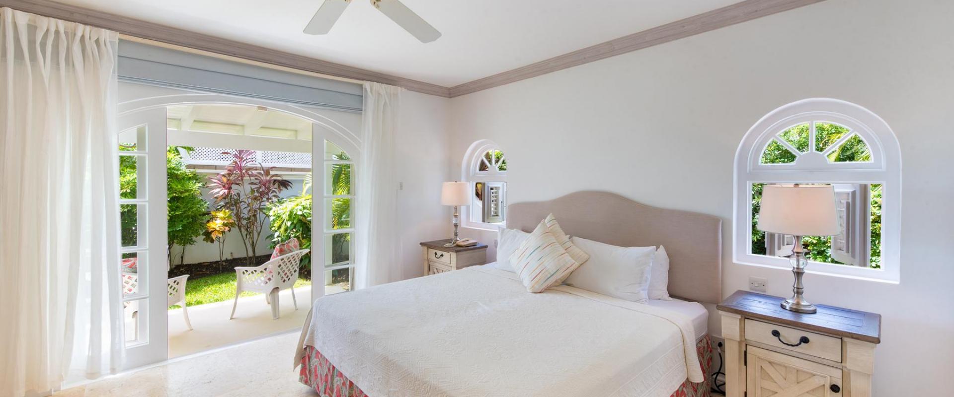 Tranquil standalone cottage bedroom at Forest Hills 23 in Royal Westmoreland, offering privacy, lush garden views, and a cozy, tropical-inspired design.