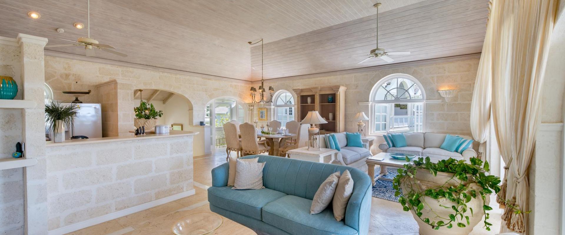 Spacious and elegantly furnished living room at Forest Hills 23 in Royal Westmoreland, Barbados, featuring plush seating, high ceilings, and natural stone accents.