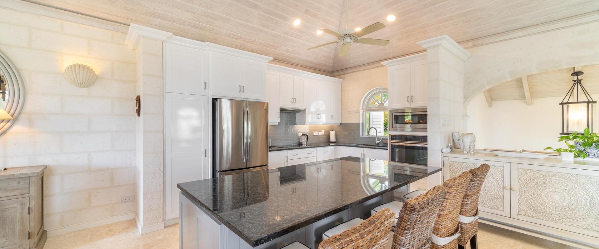 Modern kitchen at Forest Hills 25, Royal Westmoreland, Barbados, featuring a sleek island, high-end appliances, and stylish cabinetry.