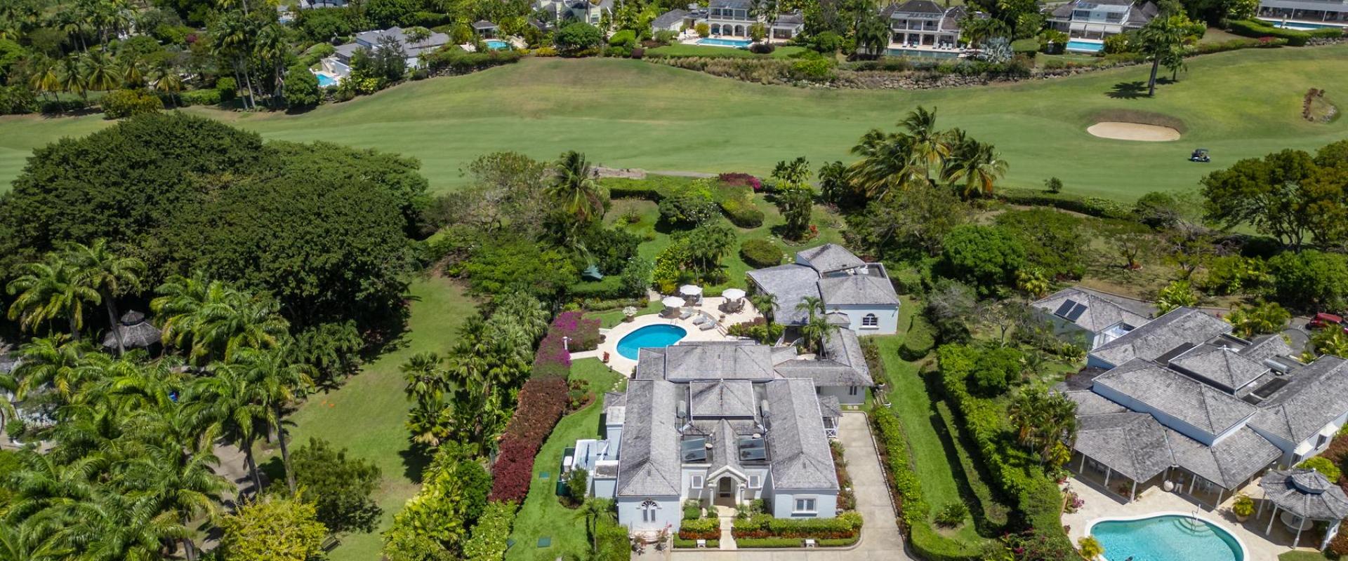 Aerial view of Ixora Royal Westmoreland, Barbados, highlighting the beautiful property, pool, and surrounding lush tropical landscaping