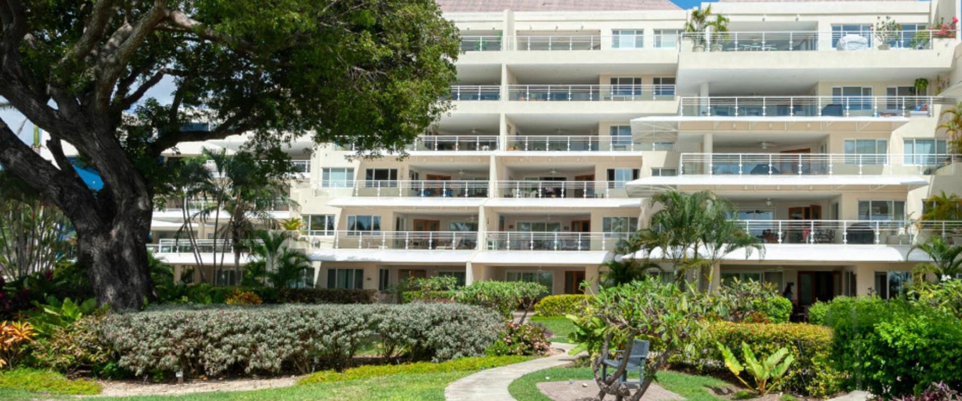 The sophisticated exterior of Palm Beach 101, featuring modern architecture, private balconies, and a lush garden setting near the ocean.