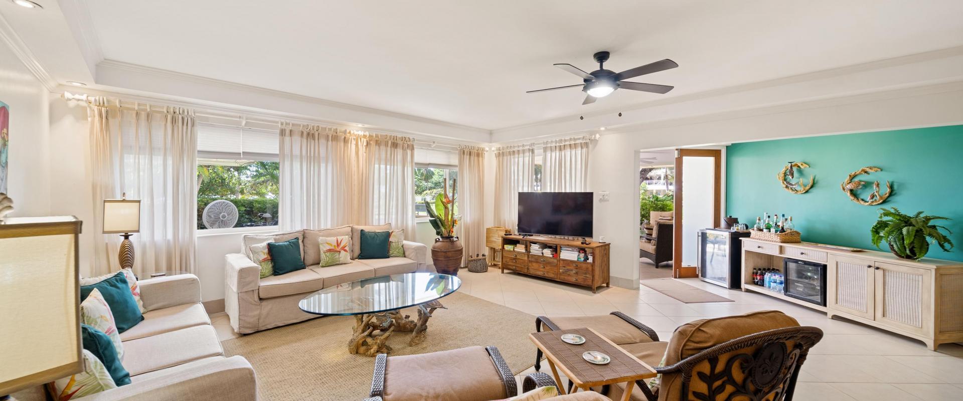 Palm Beach 102 Living Room – Condo for Rent in Barbados Spacious open plan living room at Palm Beach 102 Barbados featuring comfortable seating and garden outlook
