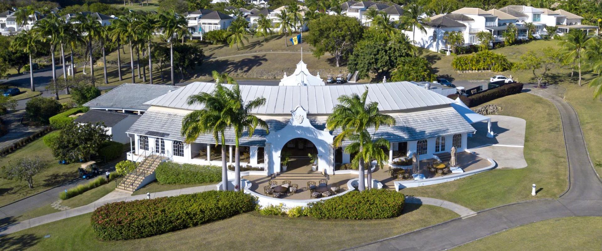 Elegant colonial-style clubhouse at Royal Westmoreland, Barbados, offering fine dining, a pro shop, and panoramic golf course views.