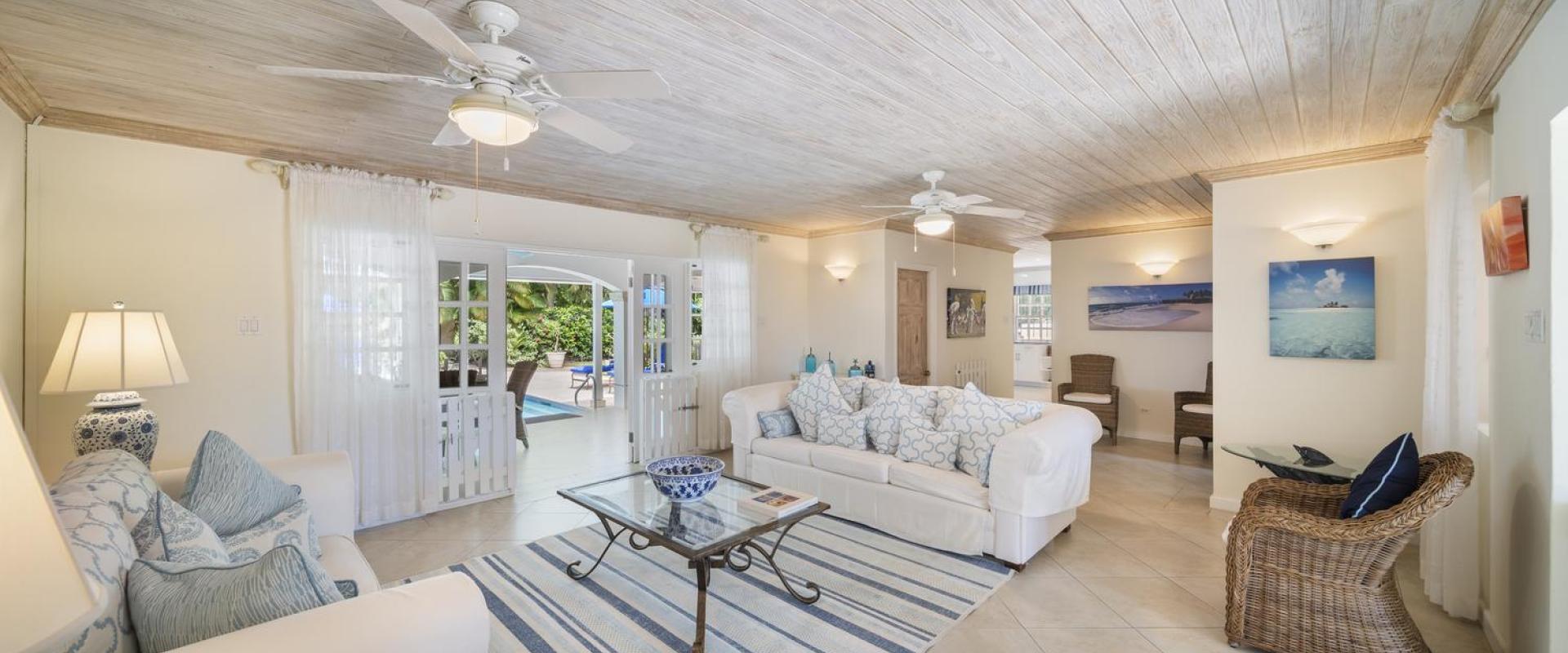 Bright and airy living room at Sandalwood House, Sandy Lane, featuring comfortable seating and access to the pool.