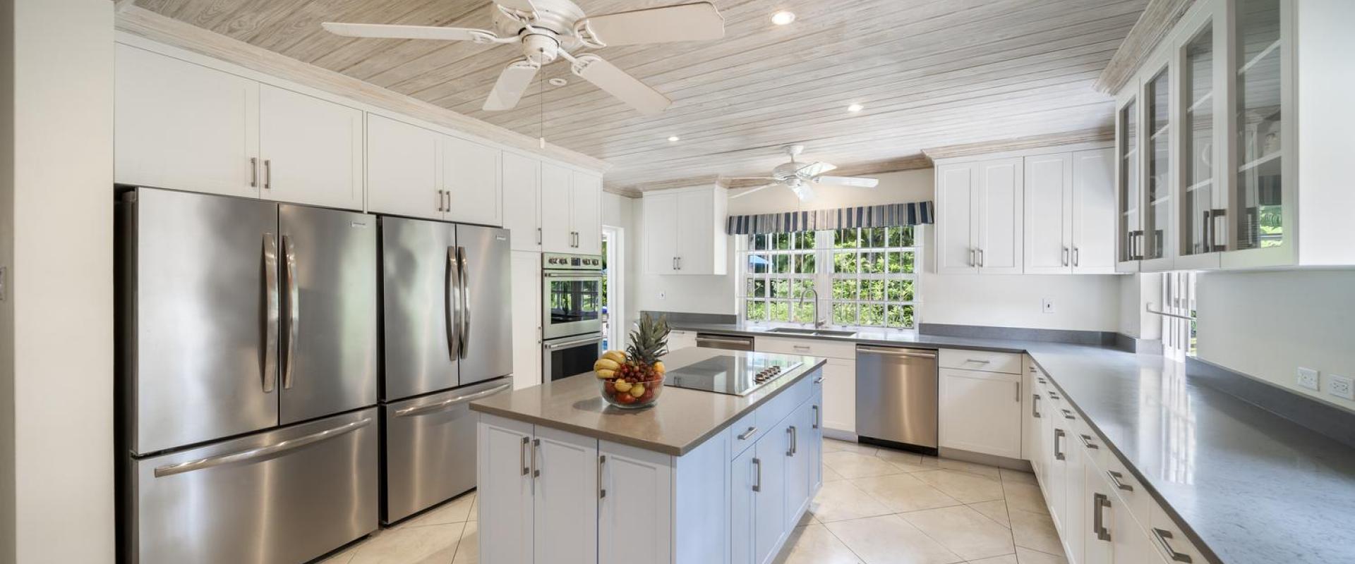 Modern, fully equipped kitchen at Sandalwood House, Barbados, with stainless steel appliances and spacious countertops.