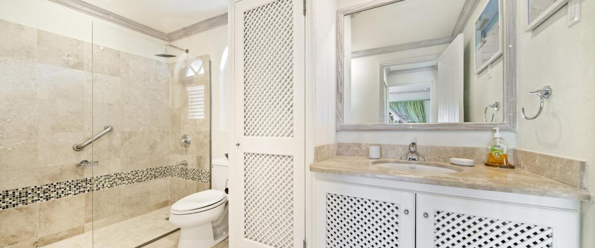 Spacious second bathroom in Seabreeze Penthouse, Sugar Hill Resort, Barbados, featuring a large walk-in shower, marble countertops, and stylish tile accents, combining luxury with convenience for a relaxing experience.