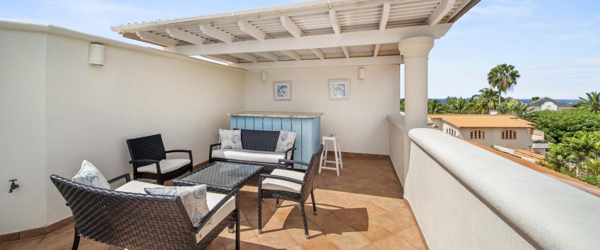 Rooftop lounge area of Seabreeze Penthouse, Sugar Hill Resort, Barbados, with comfortable outdoor seating and a private bar area, perfect for enjoying panoramic views and tropical sunsets.