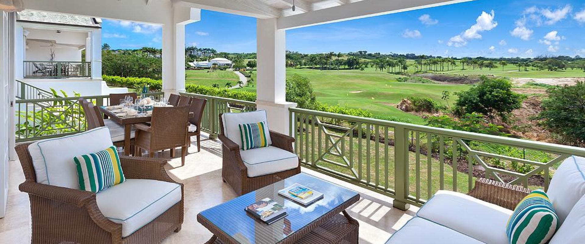Spacious covered patio at Sugar Cane Ridge 22, Royal Westmoreland, featuring outdoor seating and dining with breathtaking golf course views.