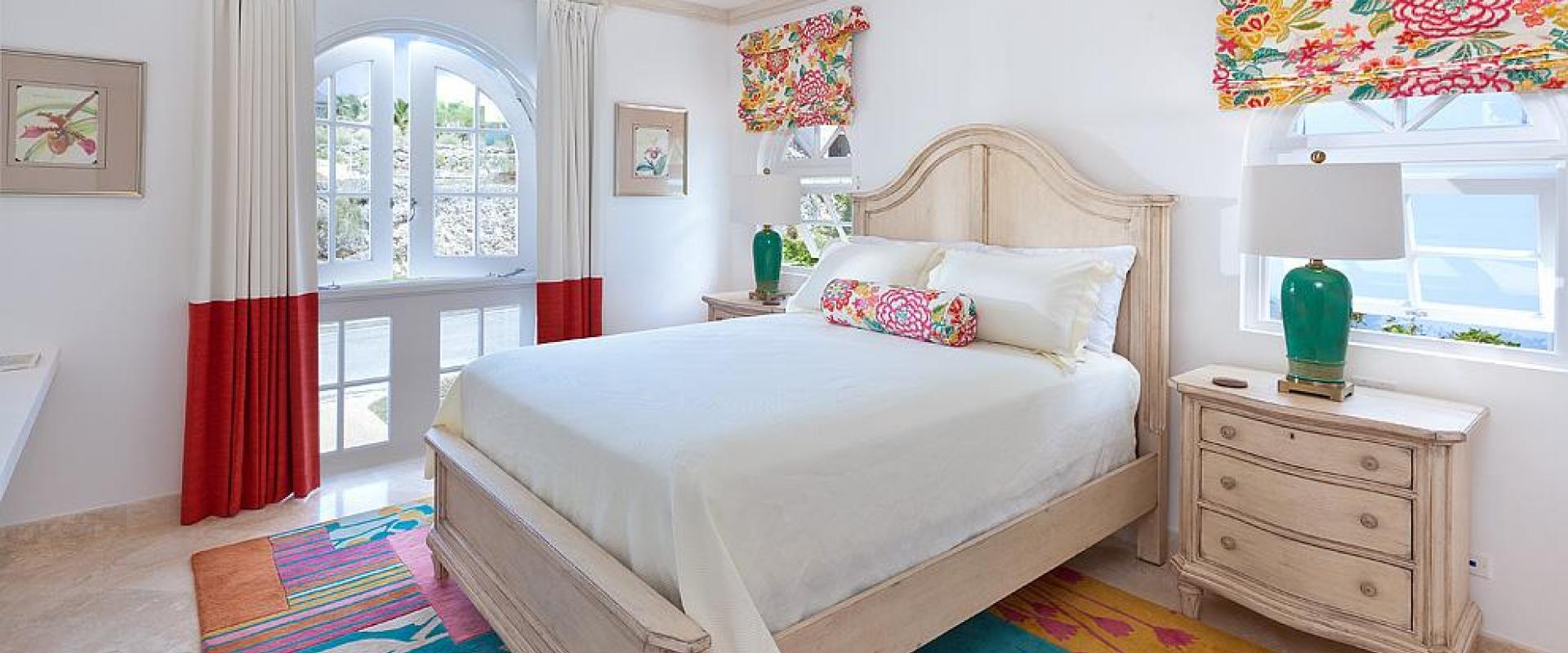 Bright and cheerful third bedroom with colorful accents, a queen-sized bed, and natural light at Sugar Cane Ridge 22.