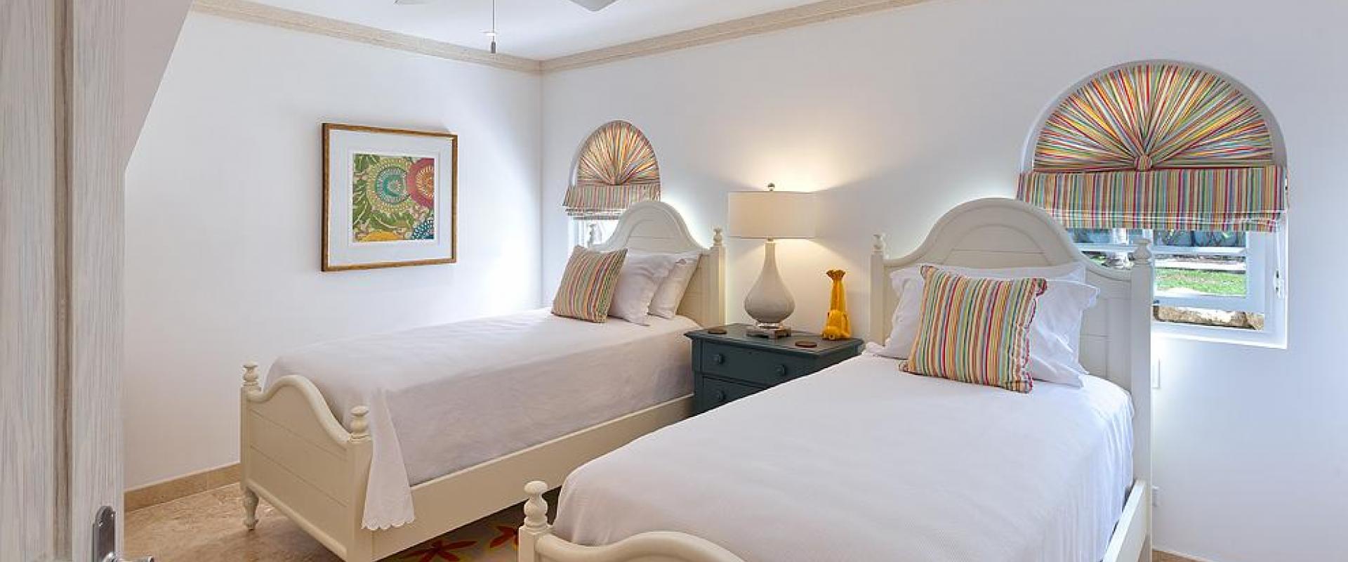 Stylish twin-bedroom with tropical-inspired décor, ideal for children or additional guests at Sugar Cane Ridge 22, Royal Westmoreland. 