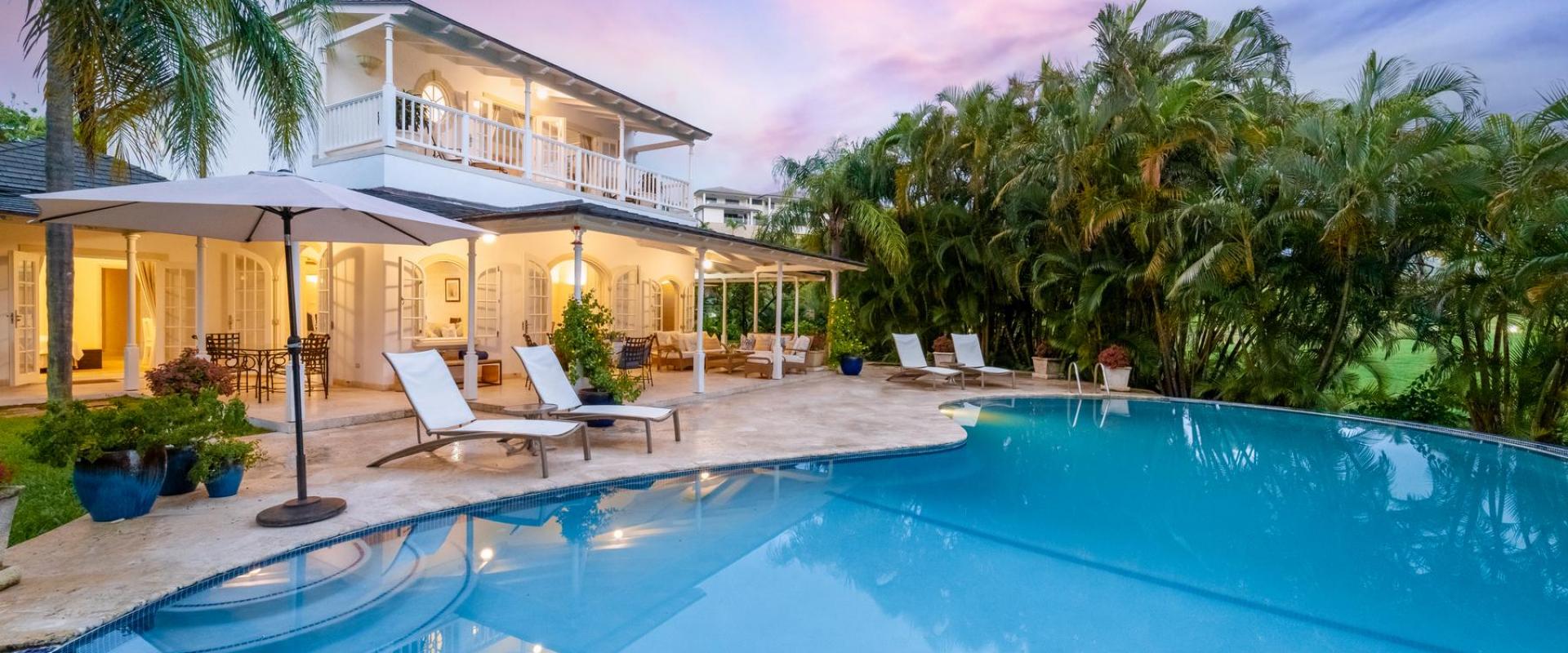Villa Rosa’s pool illuminated at twilight, creating a magical and serene ambiance in Barbados.