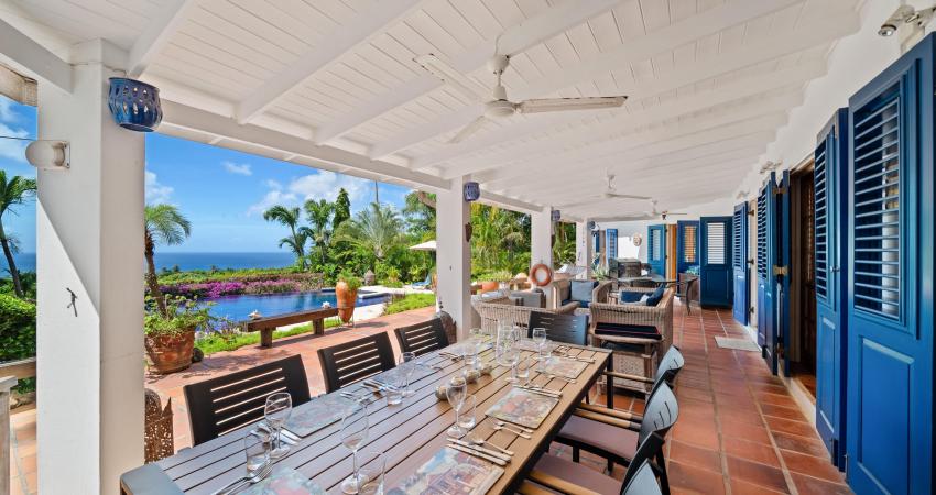 Covered outdoor dining terrace at Apples House, a luxury holiday rental villa in Rock Dundo, Barbados, overlooking the pool and Caribbean Sea